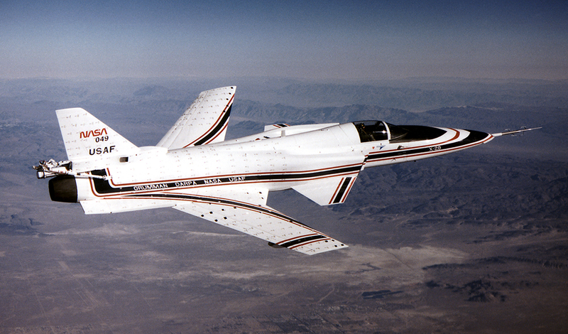 The second of two X-29 experimental forward-swept wing aircraft flies over the California desert in 1990. Strips of cloth fitted to the fuselage and wings help visualize airflow over these surfaces. (NASA)